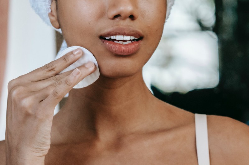 A girl cleaning her face.