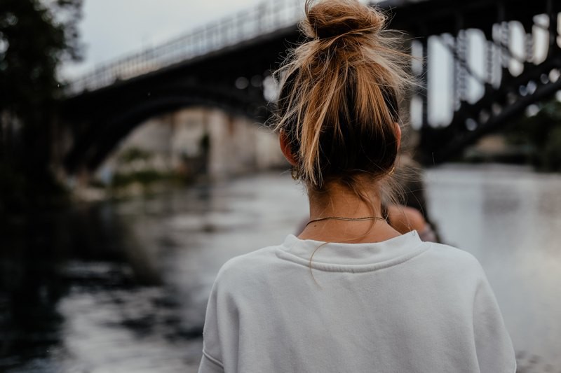 A girl swith messy bun hairstyle