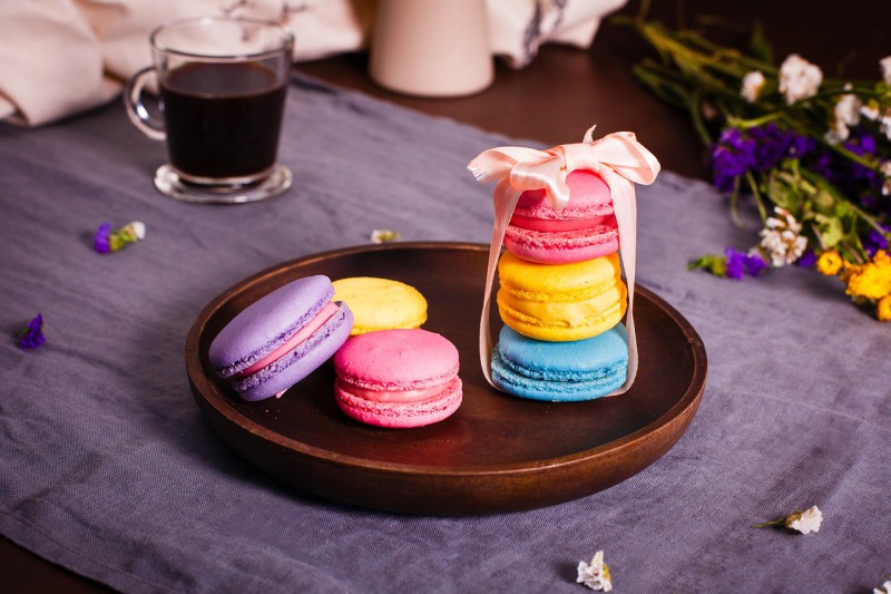 Six macaroons in bright colors served on the table
