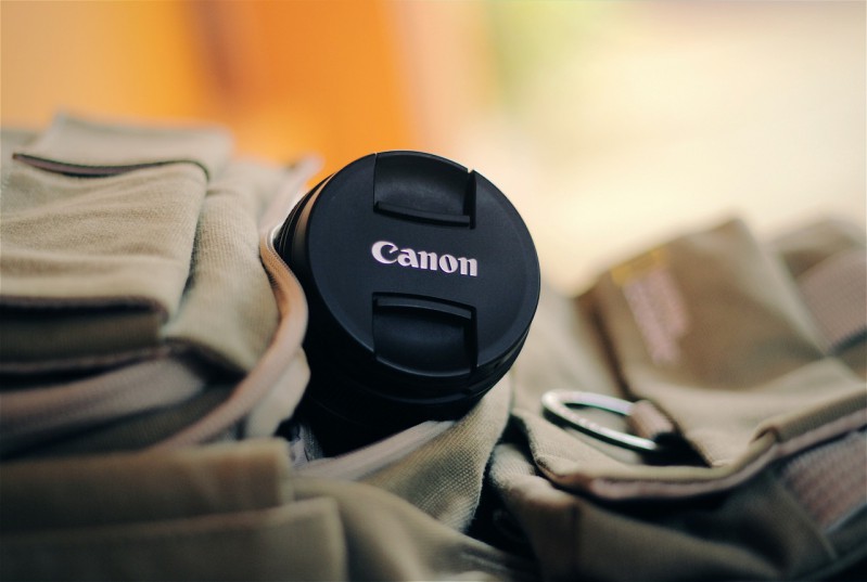 Camera lens cover with Canon logo.