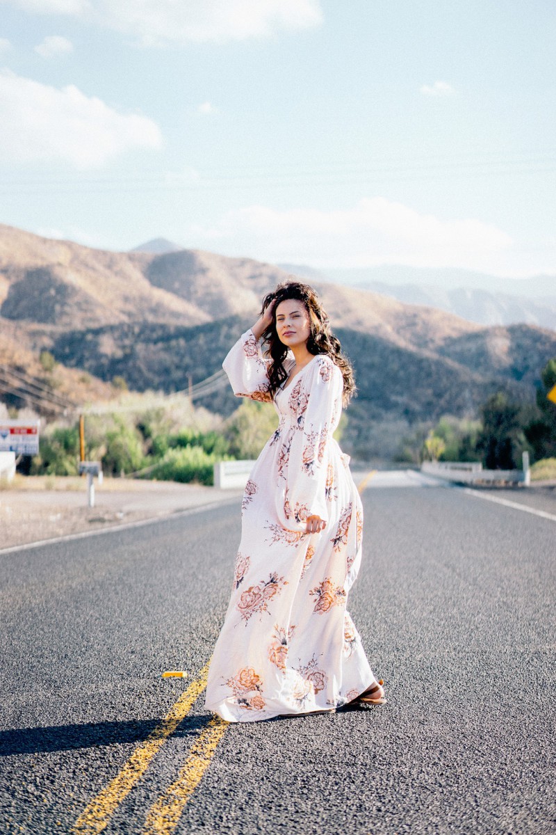 A woman in a maxi dress in the middle of the road