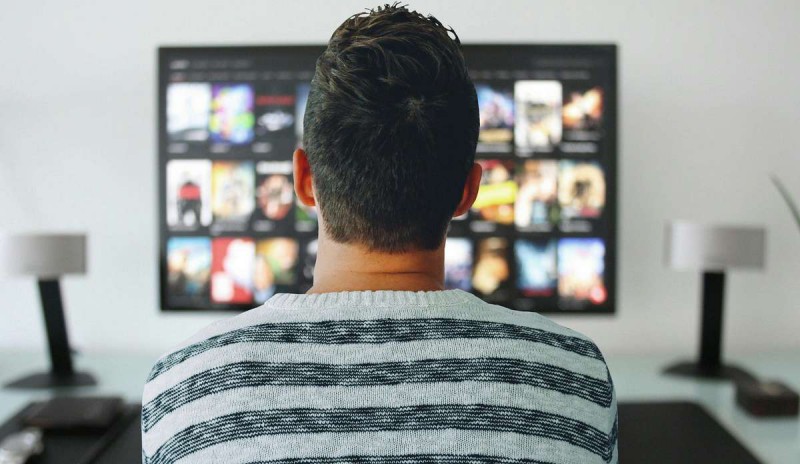 A man watching a TV