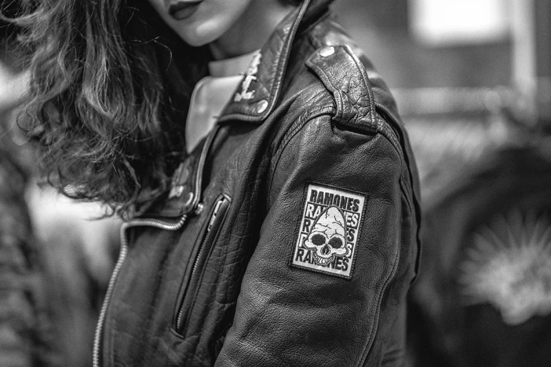 A woman wearing a leather jacket with Ramones badge