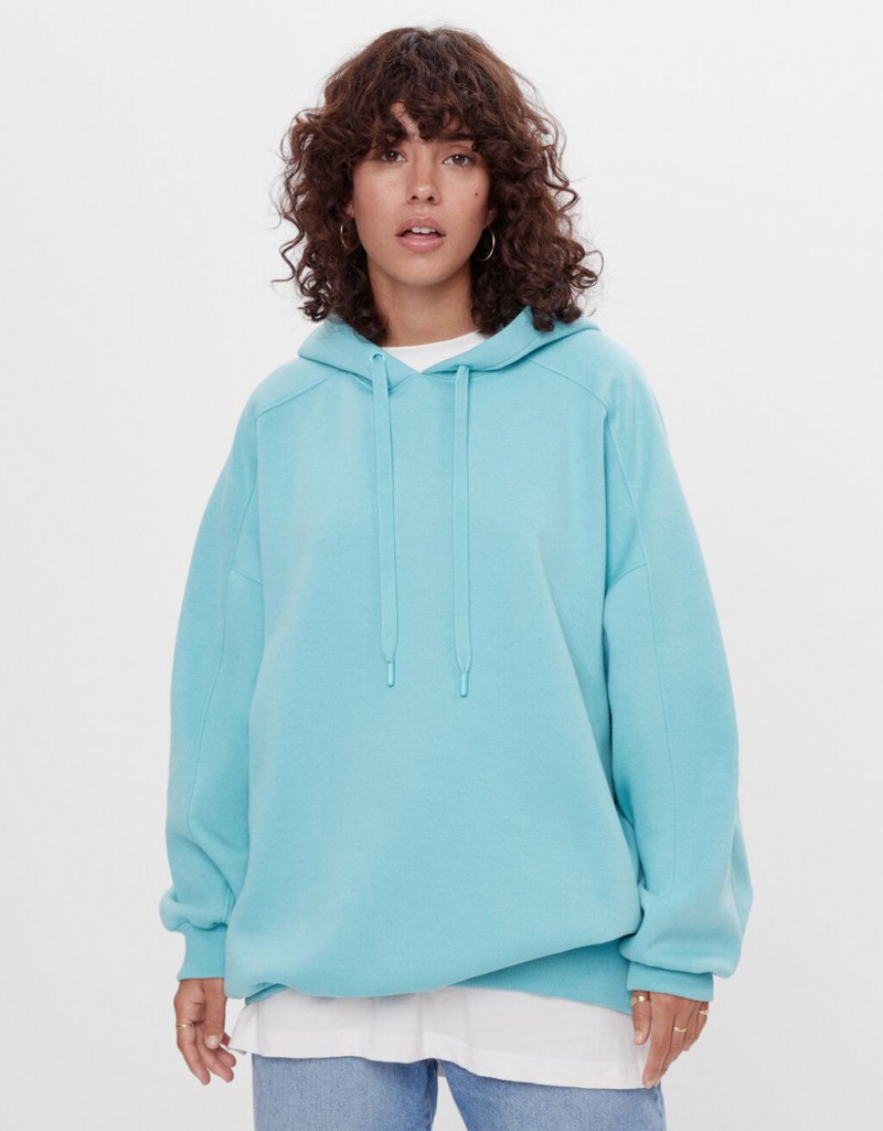 A woman in a blue sweatshirt