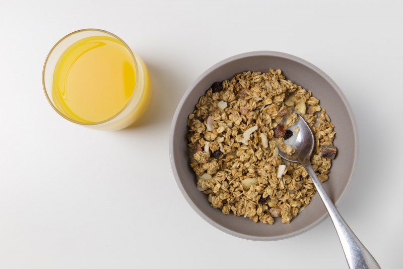 Oatmeal served in a bowl with orange juice