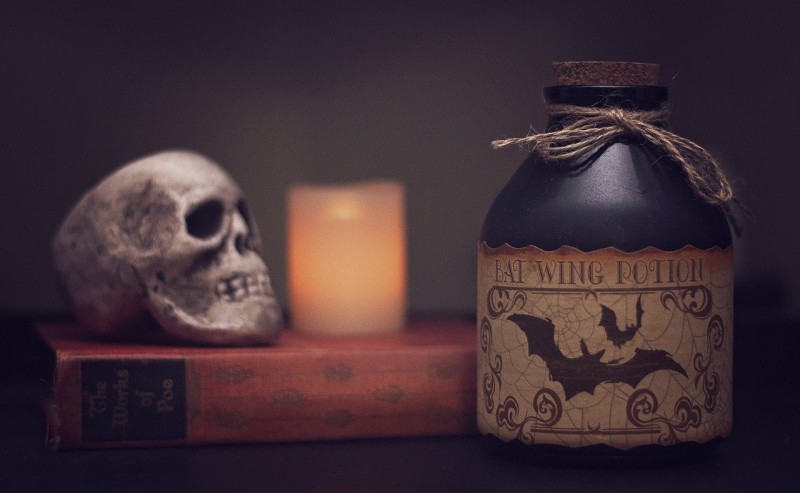 Occult items, including a human skull and a bat wing potion