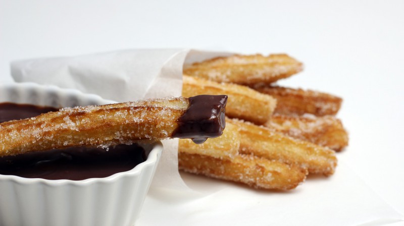 Churros served with melted chocolate