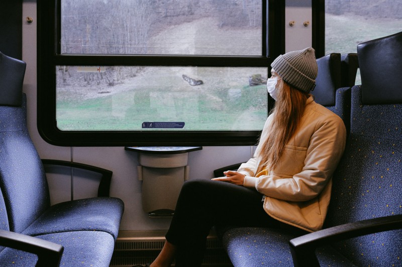 A woman wearing mask while traveling in the train