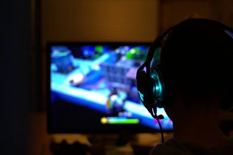 PC gamer with headphones playing a game