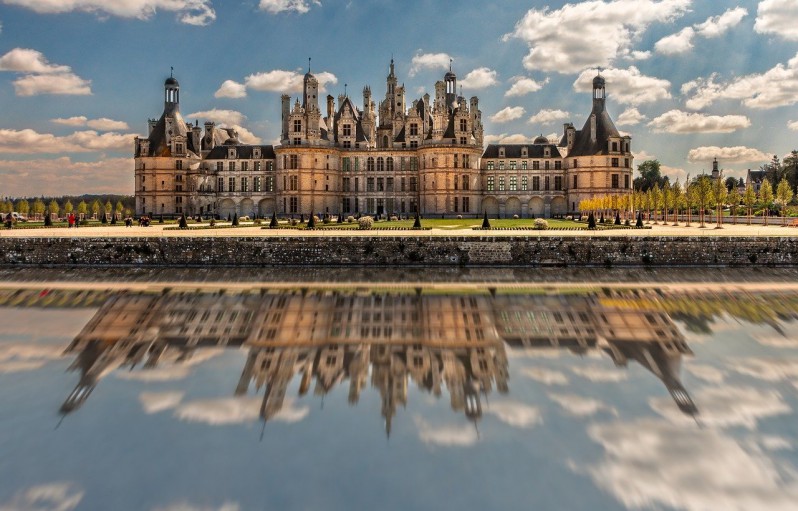 Chambord Castle in France seen from the other side of the lake.