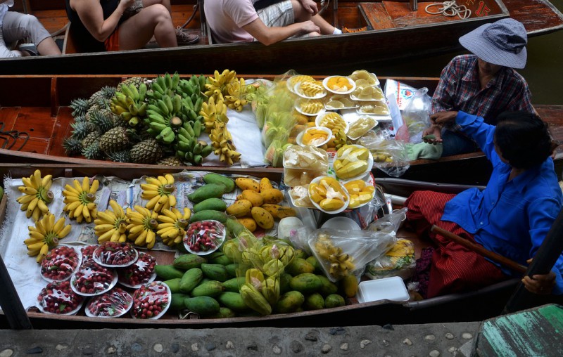 People selling fruits at floating market in Bangkok