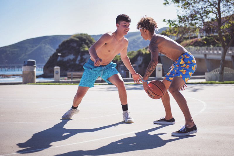 Shirtless boys playing basketball 
