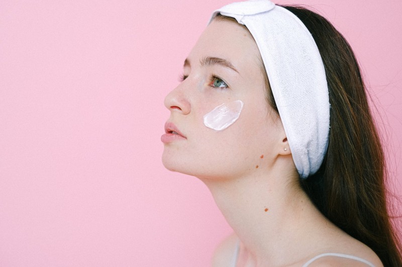 Young girl with creme on her face